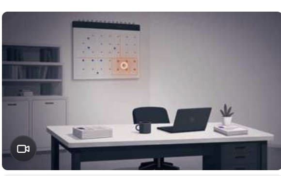 A quiet desk with a laptop, facing a calendar on the wall marking an approaching deadline